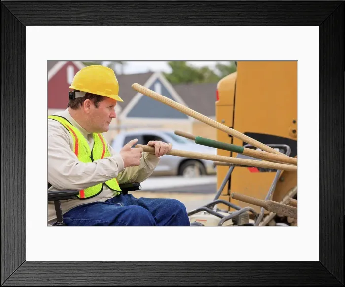 Framed Print : Construction supervisor with Spinal Cord Injury counting work tools on construction site Framed Print : Construction supervisor with Spinal Cord Injury counting work tools on construction site