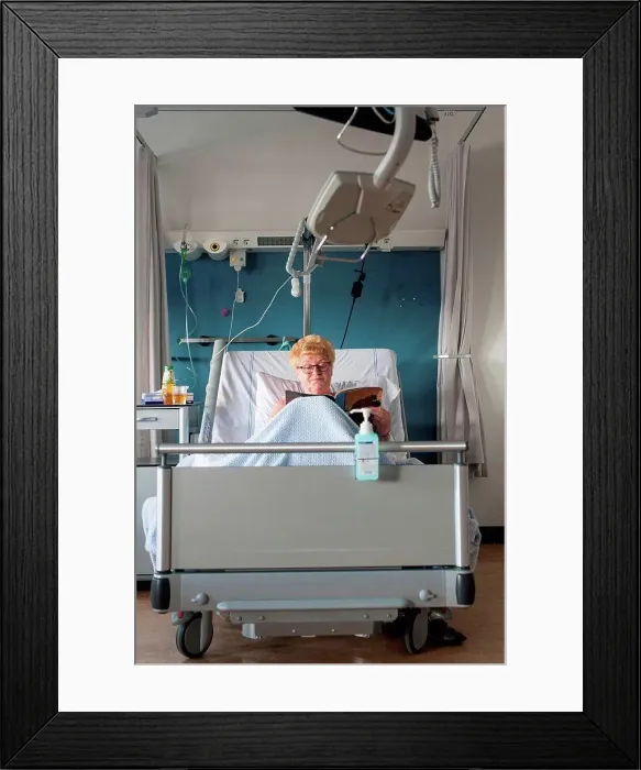 Framed Print : Patient in hospital bed reading magazine Framed Print : Patient in hospital bed reading magazine