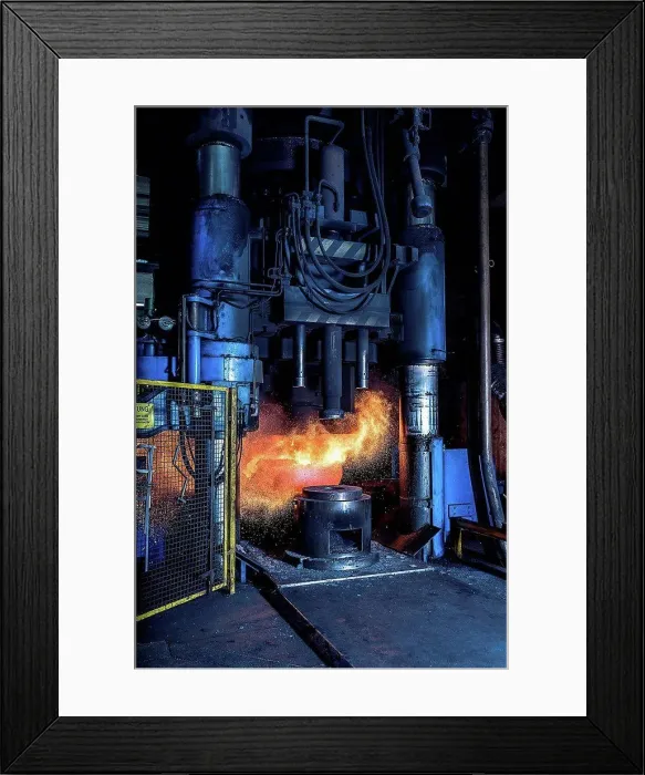 Framed Print : Manufacturing machine shaping red hot steel in foundry