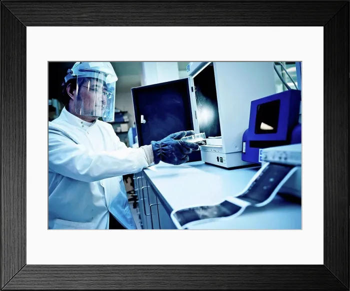Framed Print : Scientist using equipment in lab
