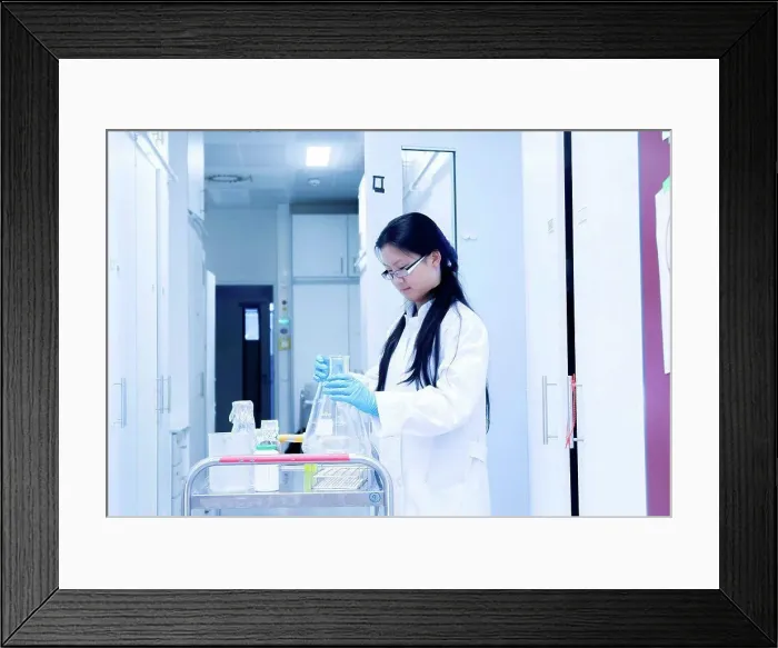 Framed Print : Female scientist preparing experiment equipment for trolley in laboratory Framed Print : Female scientist preparing experiment equipment for trolley in laboratory