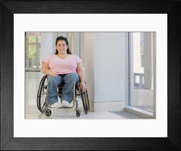 Framed Print : Woman with Spina Bifida sitting in a wheelchair and smiling Framed Print : Woman with Spina Bifida sitting in a wheelchair and smiling