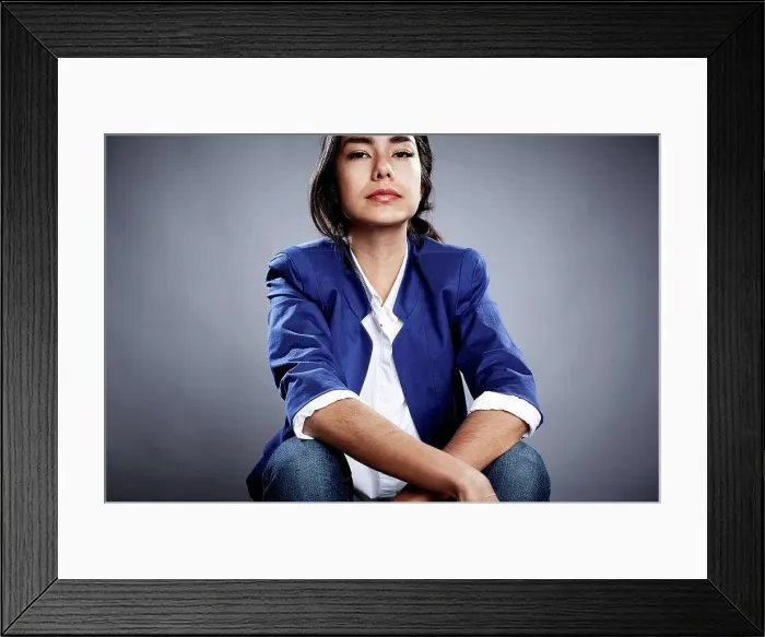 Framed Print : Portrait of young woman with serious expression