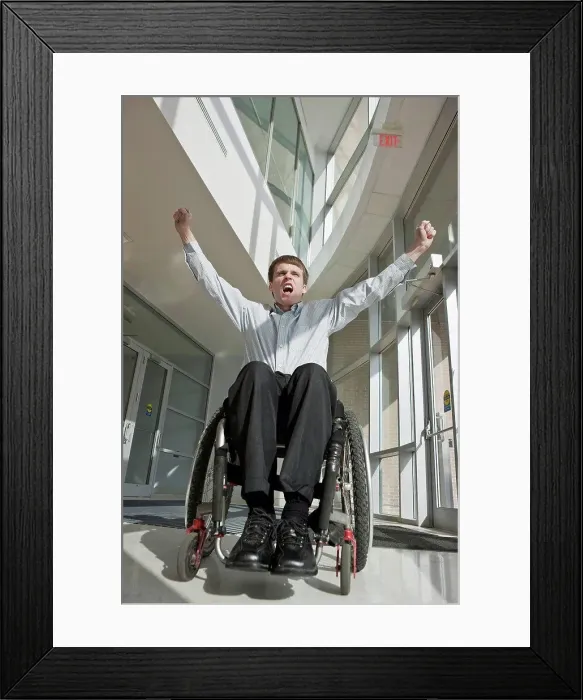 Framed Print : Businessman with spinal cord injury in a wheelchair with his arms raised Framed Print : Businessman with spinal cord injury in a wheelchair with his arms raised