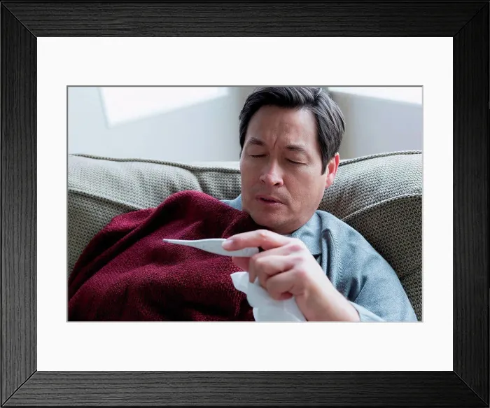 Framed Print : Mature man taking temperature Framed Print : Mature man taking temperature