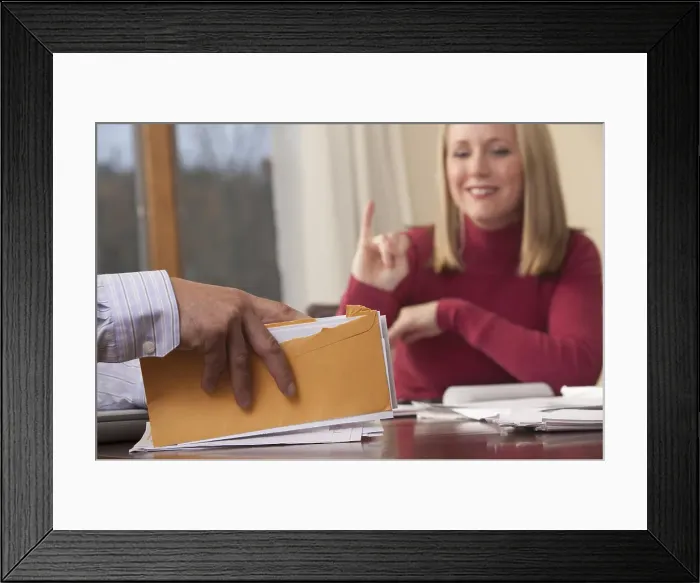Framed Print : Woman signing the word Insurance in American Sign Language while communicating with a man Framed Print : Woman signing the word Insurance in American Sign Language while communicating with a man