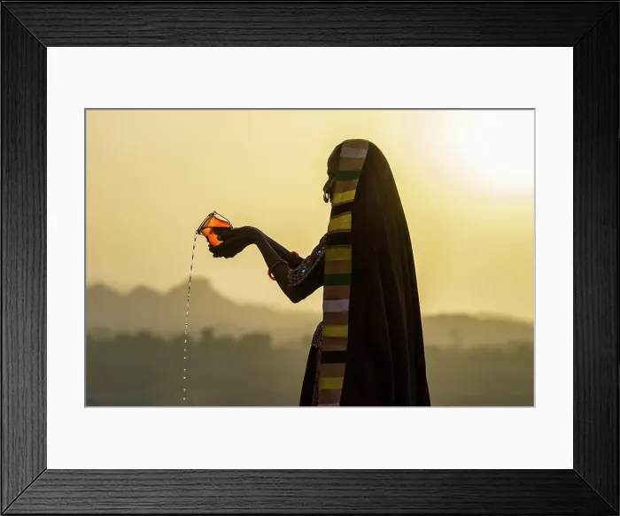 Framed Print : Ahir Woman in traditional colorful cloth pouring water at sunset, Great Rann of Kutch Desert, Gujarat, India, Asia Framed Print : Ahir Woman in traditional colorful cloth pouring water at sunset, Great Rann of Kutch Desert, Gujarat, India, Asia