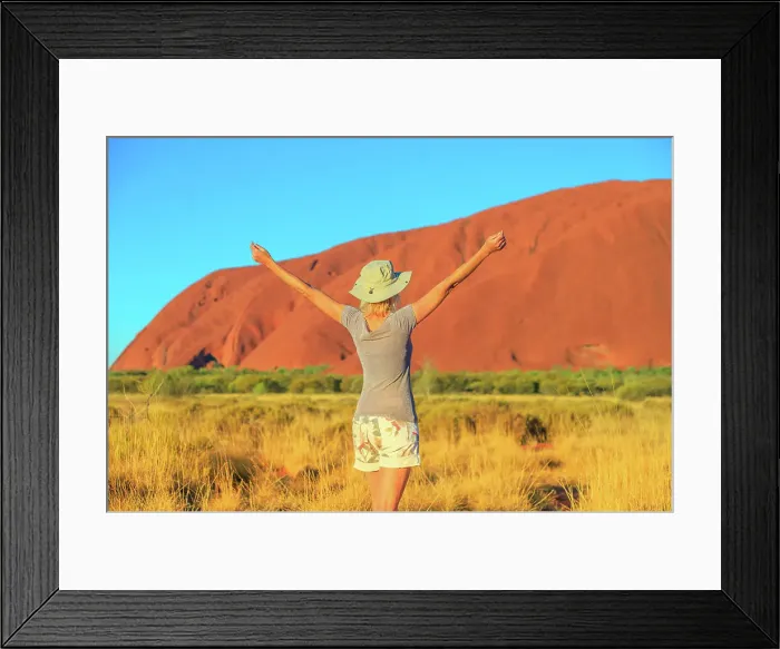 Framed Print : Carefree tourist woman with raised arms enjoys Uluru (Ayers Rock) at sunset in Uluru-Kata Tjuta National Park Framed Print : Carefree tourist woman with raised arms enjoys Uluru (Ayers Rock) at sunset in Uluru-Kata Tjuta National Park