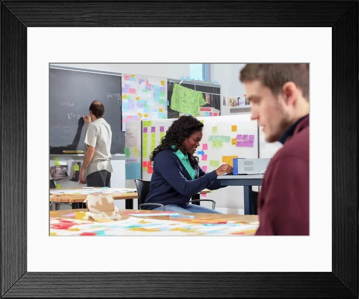 Framed Print : Engineering instructor with Aspergers writing math equations on blackboard in ideation lab Framed Print : Engineering instructor with Aspergers writing math equations on blackboard in ideation lab