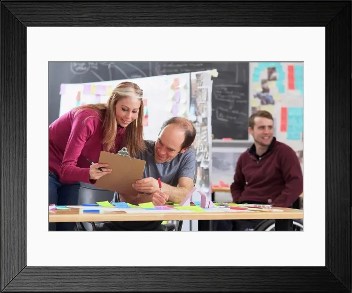Framed Print : Engineering students actively brainstorming in ideation lab