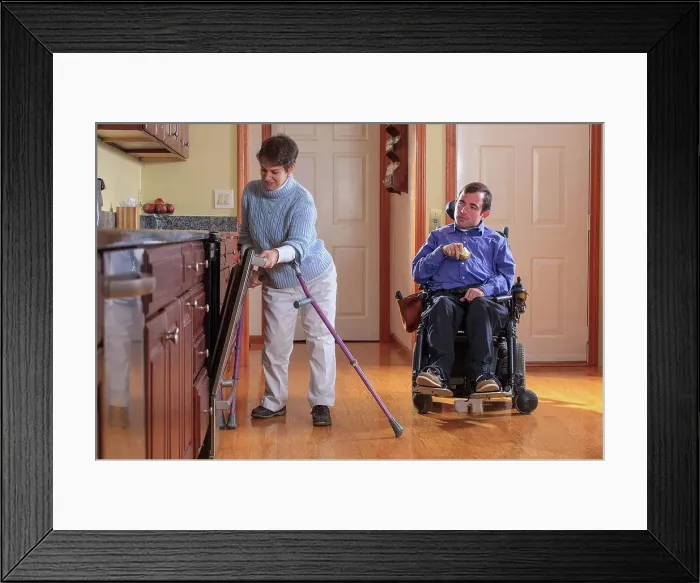 Framed Print : Man and woman with Cerebral Palsy preparing for lunch and using the dishwasher in their home kitchen Framed Print : Man and woman with Cerebral Palsy preparing for lunch and using the dishwasher in their home kitchen