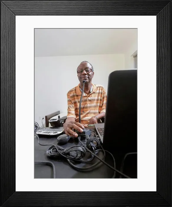 Framed Print : Man with Guillain-Barre Syndrome using his technical equipment at home office Framed Print : Man with Guillain-Barre Syndrome using his technical equipment at home office