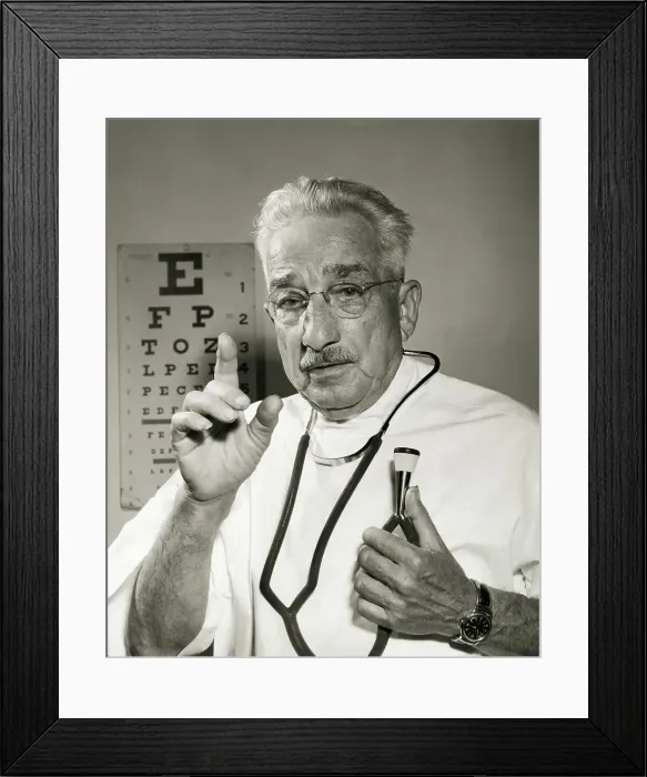 Framed Print : Portrait of a male doctor holding a stethoscope Framed Print : Portrait of a male doctor holding a stethoscope