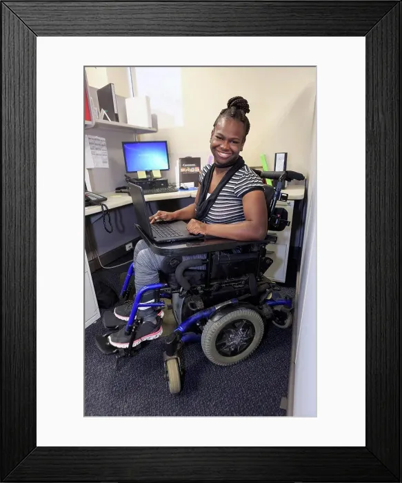 Framed Print : Teen with Cerebral Palsy working in an office Framed Print : Teen with Cerebral Palsy working in an office