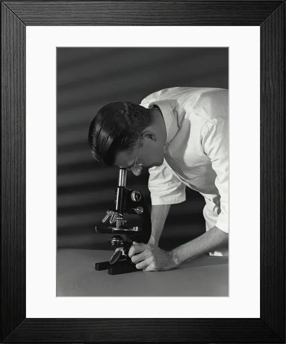 Framed Print : Vintage Photograph. Close-up of a scientist looking through a microscope Framed Print : Vintage Photograph. Close-up of a scientist looking through a microscope