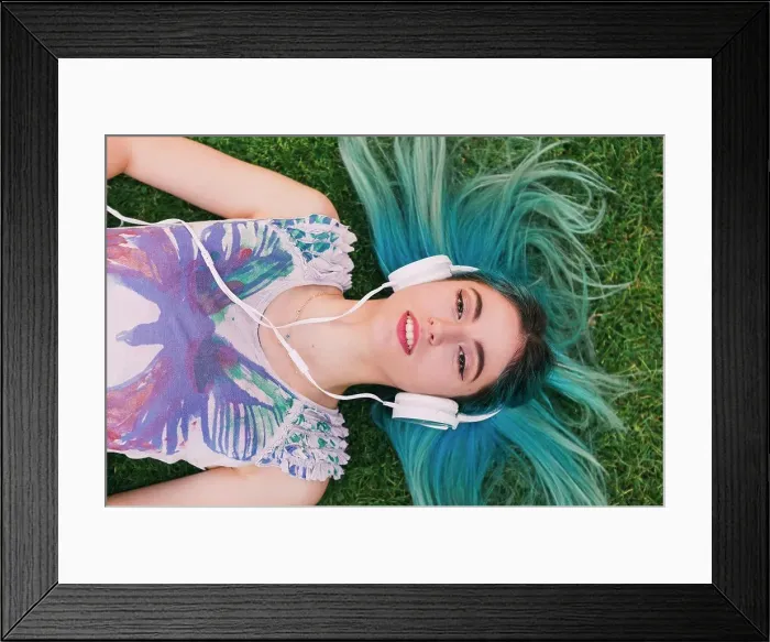Framed Print : Overhead portrait young woman with blue hair listening to music with headphones Framed Print : Overhead portrait young woman with blue hair listening to music with headphones