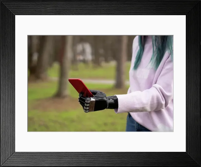 Framed Print : Woman holding smart phone with artificial limb Framed Print : Woman holding smart phone with artificial limb
