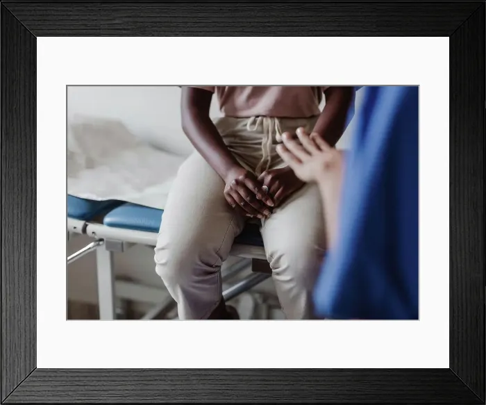 Framed Print : Midsection of female healthcare worker explaining to young patient in medical clinic Framed Print : Midsection of female healthcare worker explaining to young patient in medical clinic