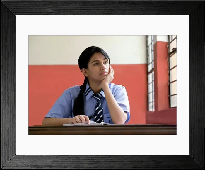 Framed Print : Girl daydreaming in a classroom Framed Print : Girl daydreaming in a classroom