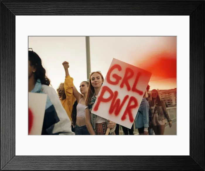 Framed Print : Portrait of women protesting with friends for human rights in city against sky