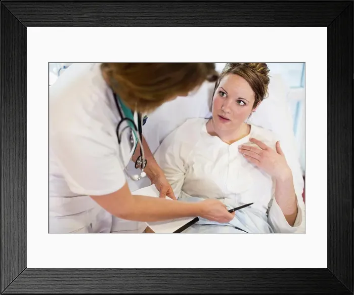 Framed Print : High angle view of female patient communicating with doctor in hospital ward