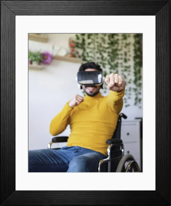 Framed Print : Smiling disable man wearing virtual reality headset punching at home Framed Print : Smiling disable man wearing virtual reality headset punching at home
