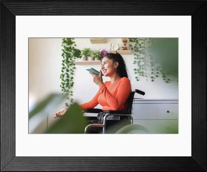 Framed Print : Smiling disabled woman talking on mobile phone at home Framed Print : Smiling disabled woman talking on mobile phone at home