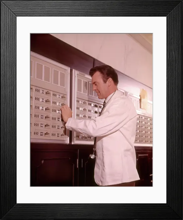 Framed Print : 1960s MEDICAL DOCTOR RETRIEVING SUPPLIES FROM SECURE STORAGE