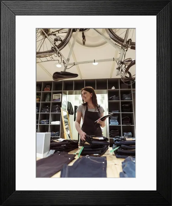 Framed Print : Smiling owner with digital tablet analyzing purchase order at boutique Framed Print : Smiling owner with digital tablet analyzing purchase order at boutique