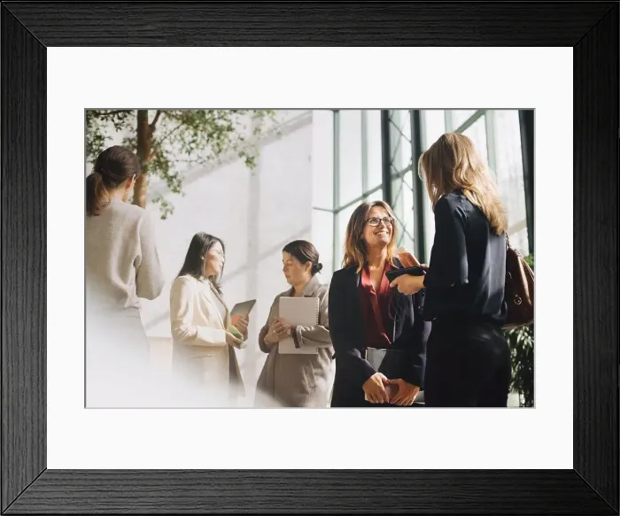 Framed Print : Multi-ethnic female professionals talking at conference event Framed Print : Multi-ethnic female professionals talking at conference event