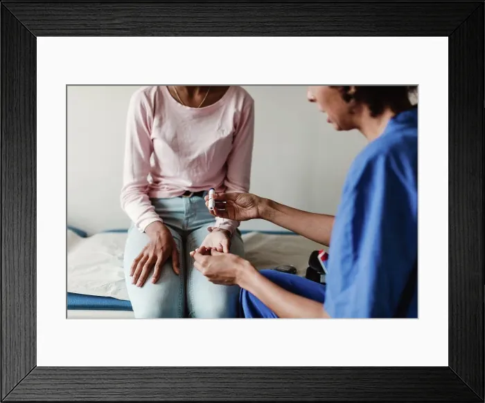 Framed Print : Nurse checking blood sugar of patient in medical examination room Framed Print : Nurse checking blood sugar of patient in medical examination room