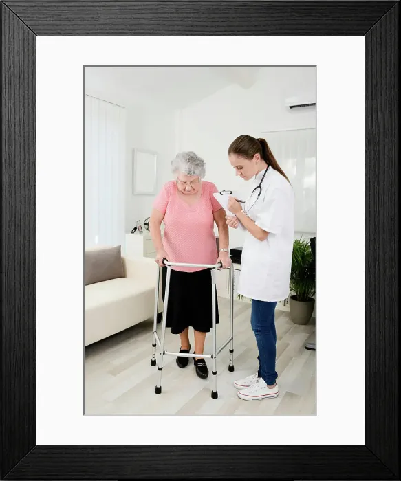 Framed Print : Young doctor checking rehab medical progress to elderly woman at home Framed Print : Young doctor checking rehab medical progress to elderly woman at home