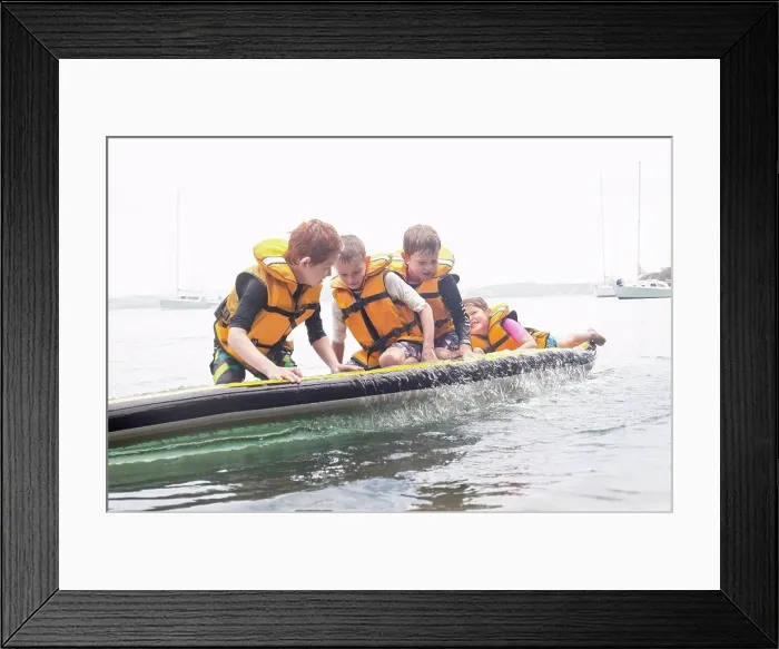 Framed Print : Brothers and sister about to fall from paddleboard into sea Framed Print : Brothers and sister about to fall from paddleboard into sea