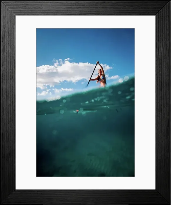 Framed Print : Woman paddleboarding on ocean