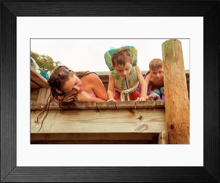 Framed Print : Mother with two sons peering over jetty looking at hermit crab Framed Print : Mother with two sons peering over jetty looking at hermit crab