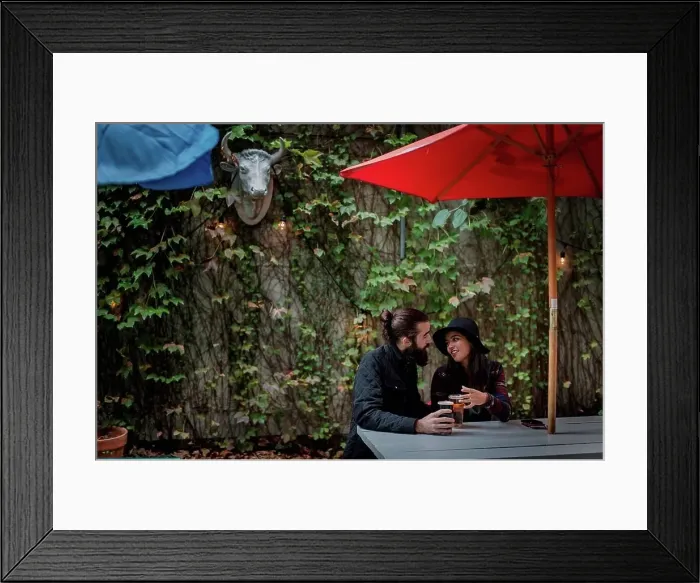 Framed Print : Young couple chatting in beer garden in evening, Brooklyn, New York, USA Framed Print : Young couple chatting in beer garden in evening, Brooklyn, New York, USA