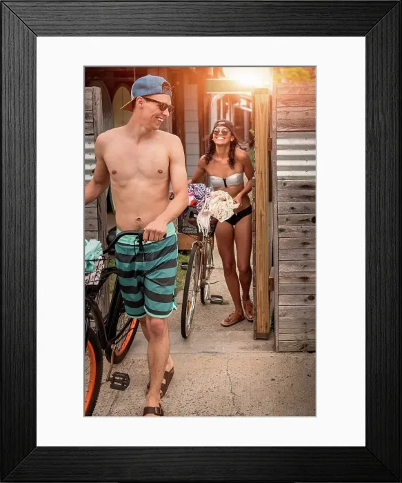 Framed Print : Young couple pushing bicycles through gate, Rockaway Beach, New York State, USA Framed Print : Young couple pushing bicycles through gate, Rockaway Beach, New York State, USA
