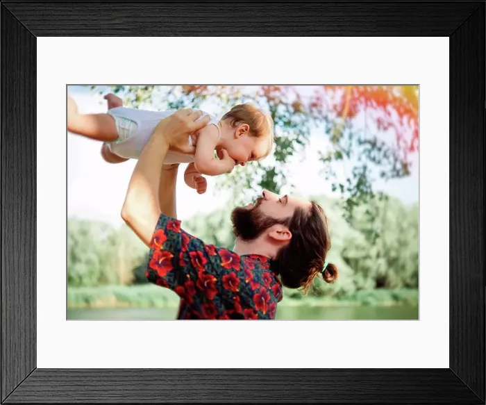 Framed Print : Man lifting up baby girl by lake, Arezzo, Tuscany, Italy
