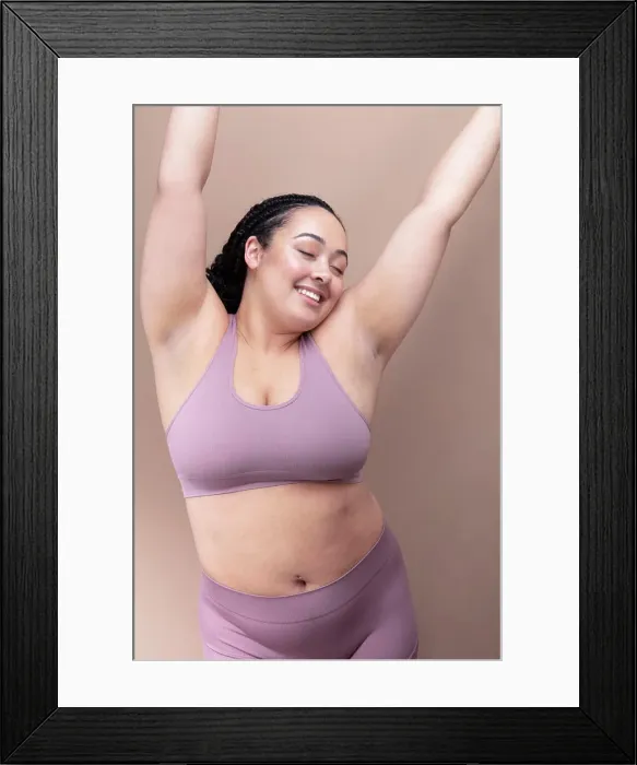 Framed Print : Studio shot of smiling woman in underwear with eyes closed and arms raised Framed Print : Studio shot of smiling woman in underwear with eyes closed and arms raised