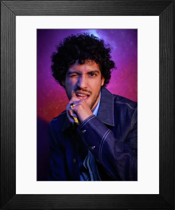Framed Print : Studio portrait of mid adult man winking Framed Print : Studio portrait of mid adult man winking