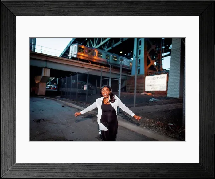 Framed Print : Young woman dancing in street, smiling Framed Print : Young woman dancing in street, smiling