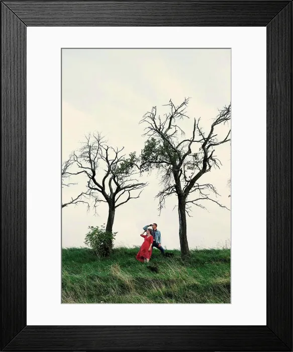 Framed Print : Pregnant couple looking out from hillside Framed Print : Pregnant couple looking out from hillside
