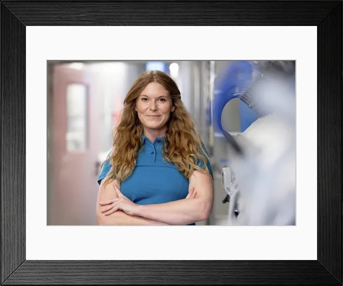Framed Print : Smiling technician standing with arms crossed in factory Framed Print : Smiling technician standing with arms crossed in factory