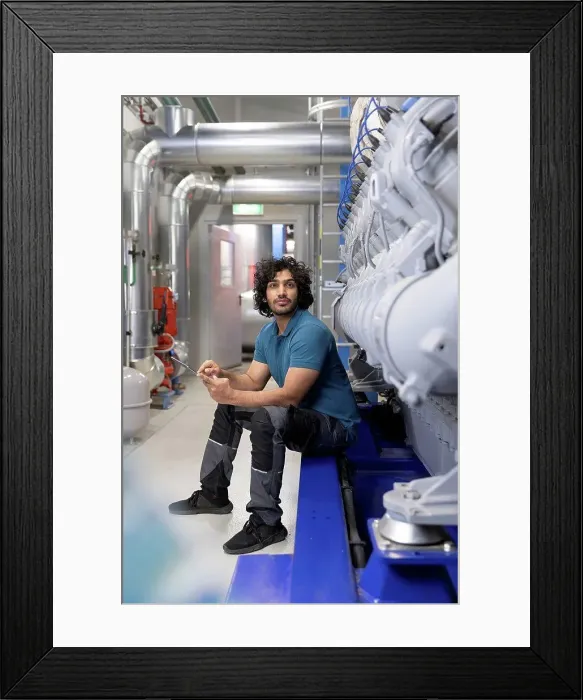 Framed Print : Technician holding tablet PC sitting in factory