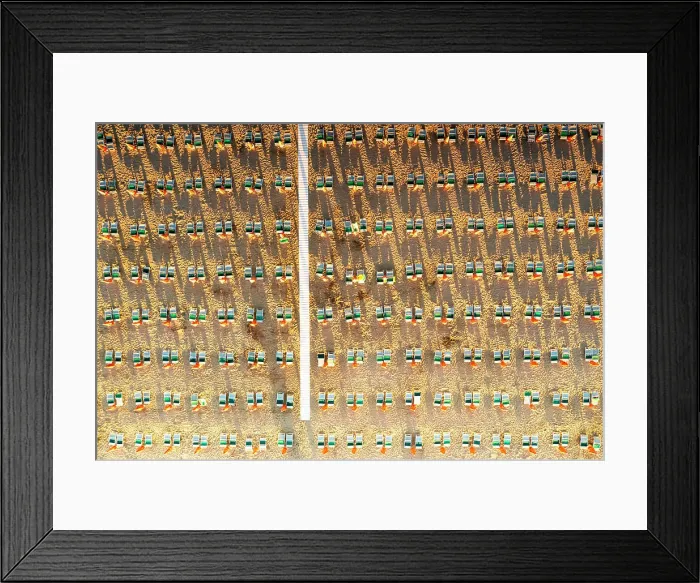Framed Print : Aerial view of rows of lounge chairs and sunbeds on empty sand beach Framed Print : Aerial view of rows of lounge chairs and sunbeds on empty sand beach