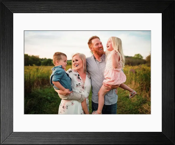 Framed Print : Smiling parents holding children in rural area Framed Print : Smiling parents holding children in rural area
