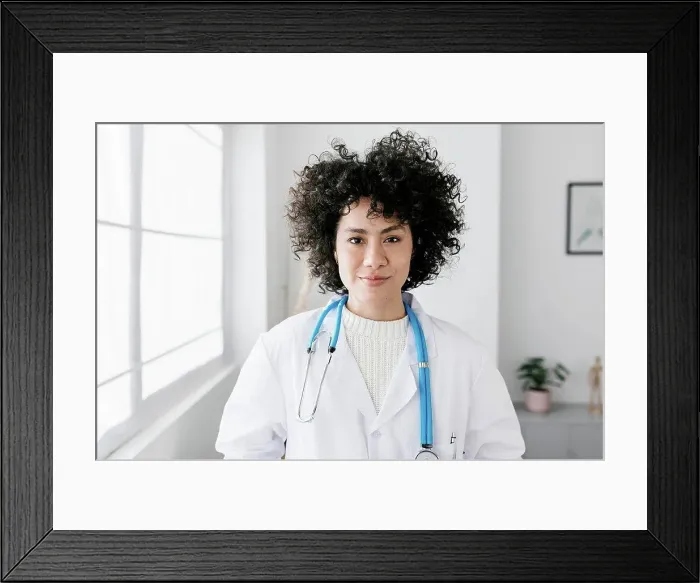 Framed Print : Doctor with curly hair at medical clinic Framed Print : Doctor with curly hair at medical clinic