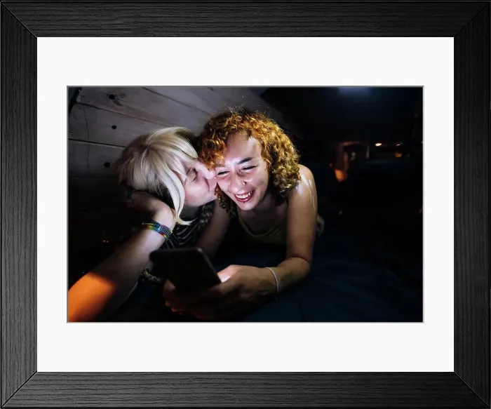 Framed Print : Young woman kissing her partner Framed Print : Young woman kissing her partner