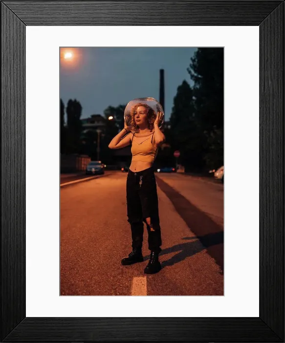 Framed Print : Young woman standing on street with glass bowl on her head Framed Print : Young woman standing on street with glass bowl on her head