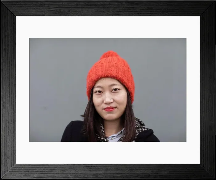 Framed Print : Portrait of a young woman wearing orange hat Framed Print : Portrait of a young woman wearing orange hat